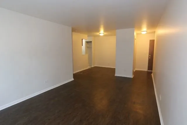 a view of a room with wooden floor