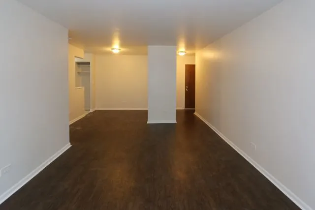 an empty room with wooden floor