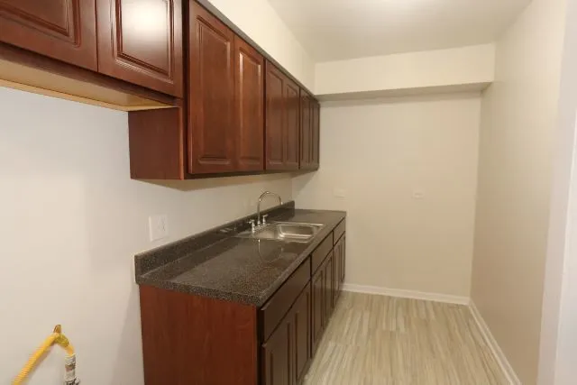 a room with a sink and cabinets