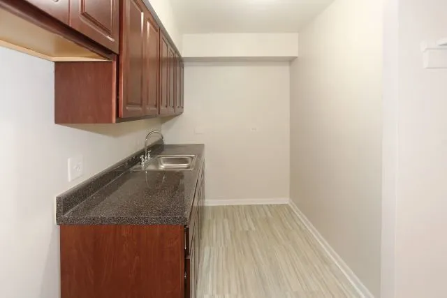 a bathroom with a sink and cabinets