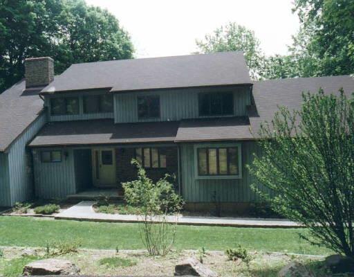 153 Oscaleta Road Ridgefield, CT 06877 - Photo 1 of 1 a front view of a house with a yard and garage