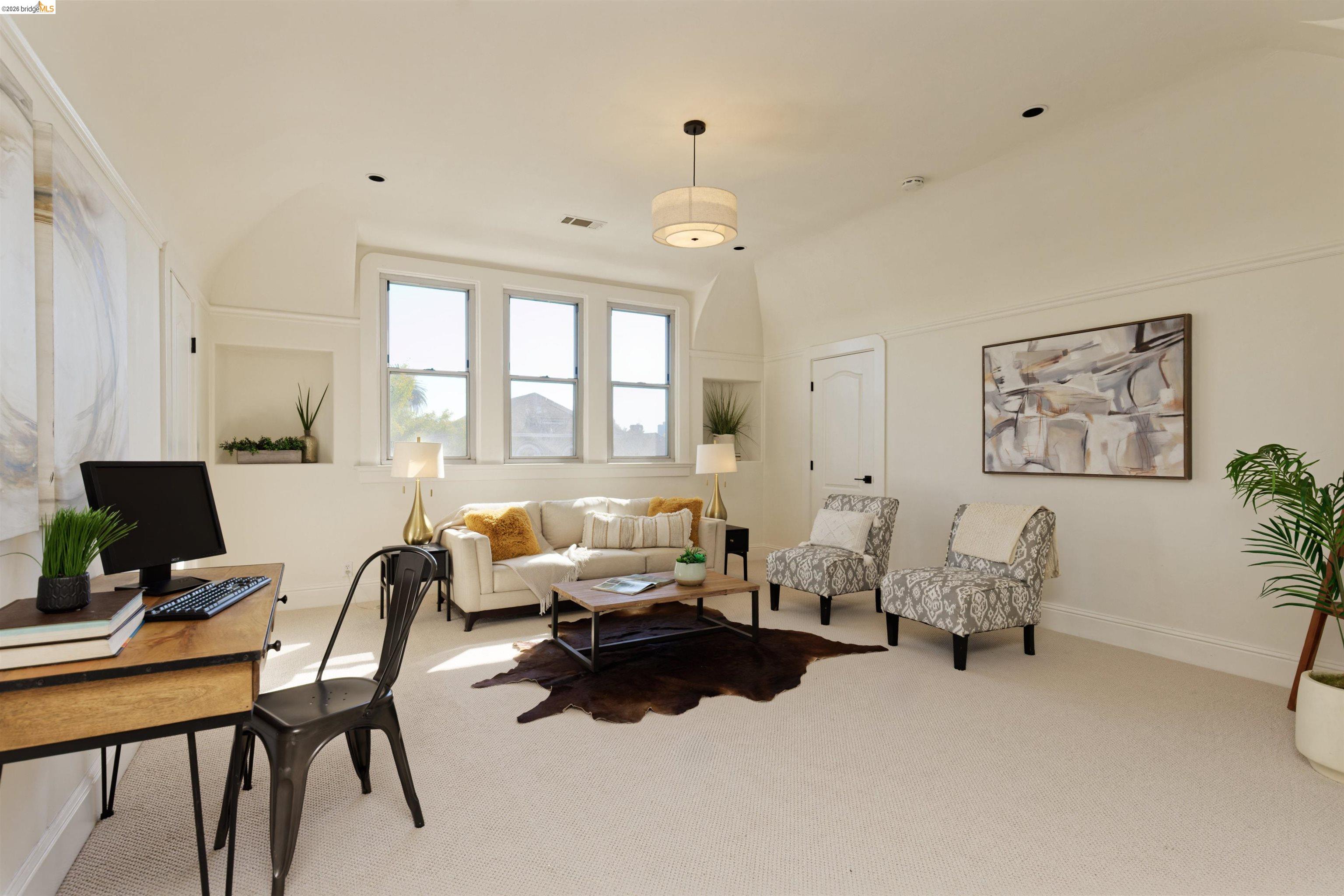 1033 Magnolia Street Oakland, CA 94607 - Photo 4 of 4 a living room with furniture wooden floor and a large window