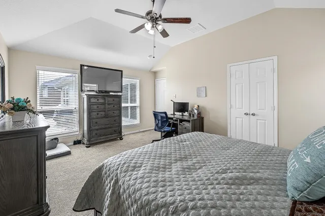 a large bedroom with bed and window