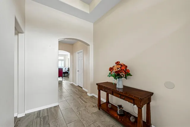 a vase of flowers sitting on a floor