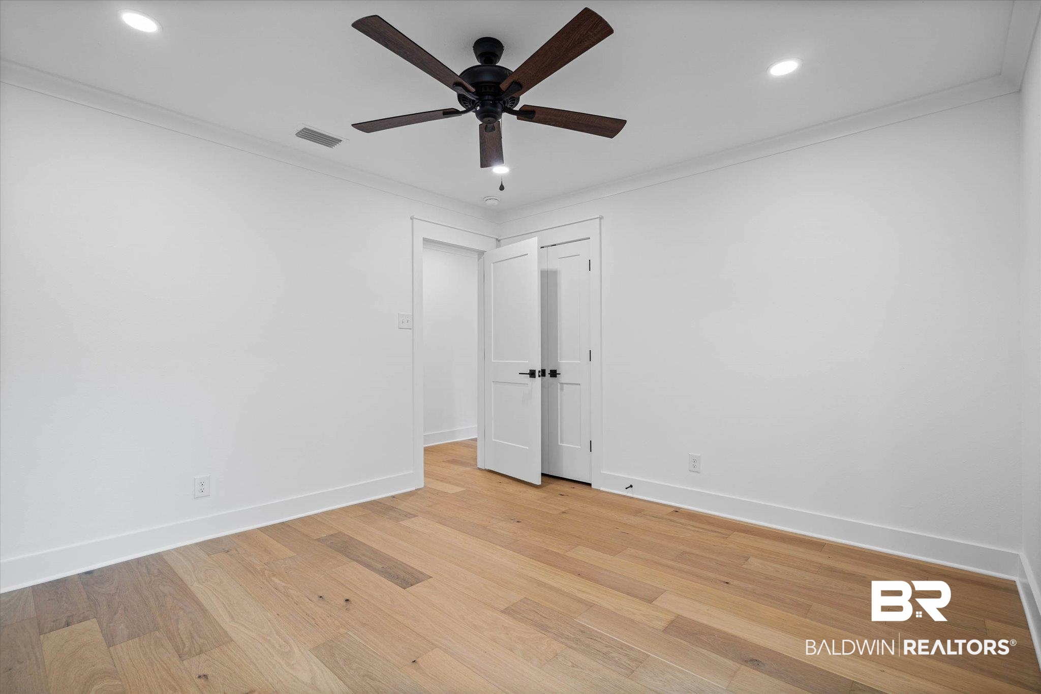 11 Schwaemmle Drive Mobile, AL 36608 - Photo 21 of 32 Unfurnished room featuring light wood-style flooring, ceiling fan, recessed lighting, and crown molding