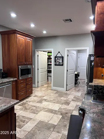 a large kitchen with cabinets and stainless steel appliances