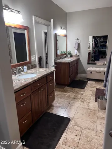 a bathroom with a sink vanity and mirror