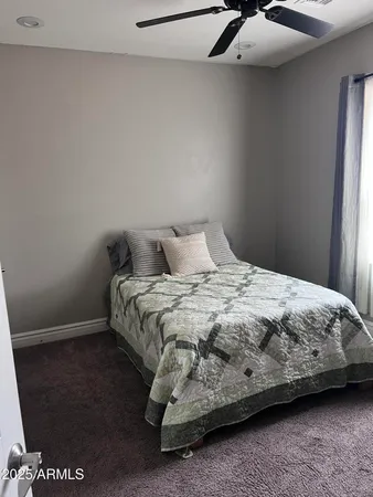 a spacious bedroom with two beds and a couch