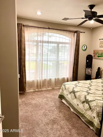 a bedroom with a bed and large window