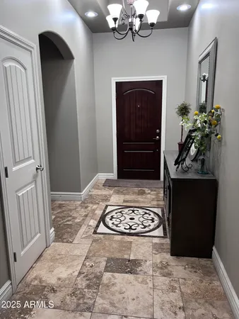 a bedroom with a bed and a chandelier