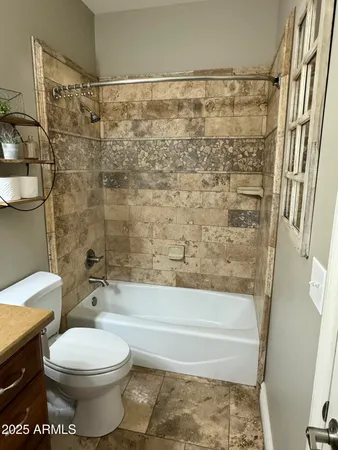a bathroom with a bathtub and shower