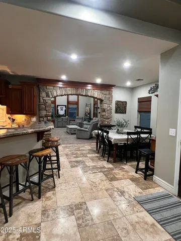 a living room with lots of furniture and kitchen view