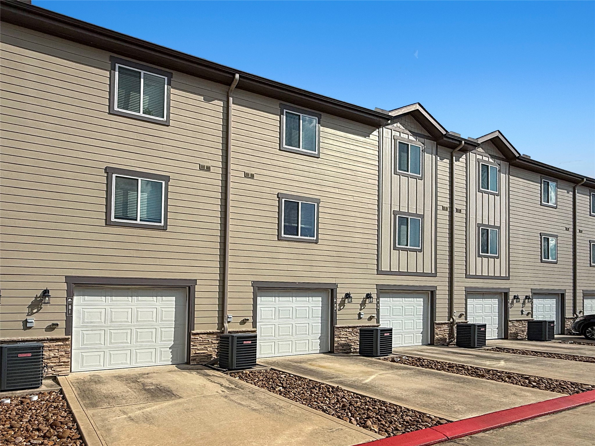 12603 Telge Road, Unit 8EH Cypress, TX 77429 - Photo 3 of 32 a front view of a house with a yard
