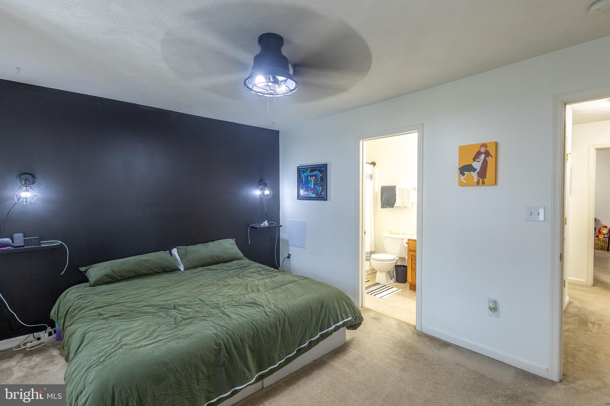 336 4th Street Colonial Beach, VA 22443 - Photo 21 of 23 a bedroom with a bed and a chandelier
