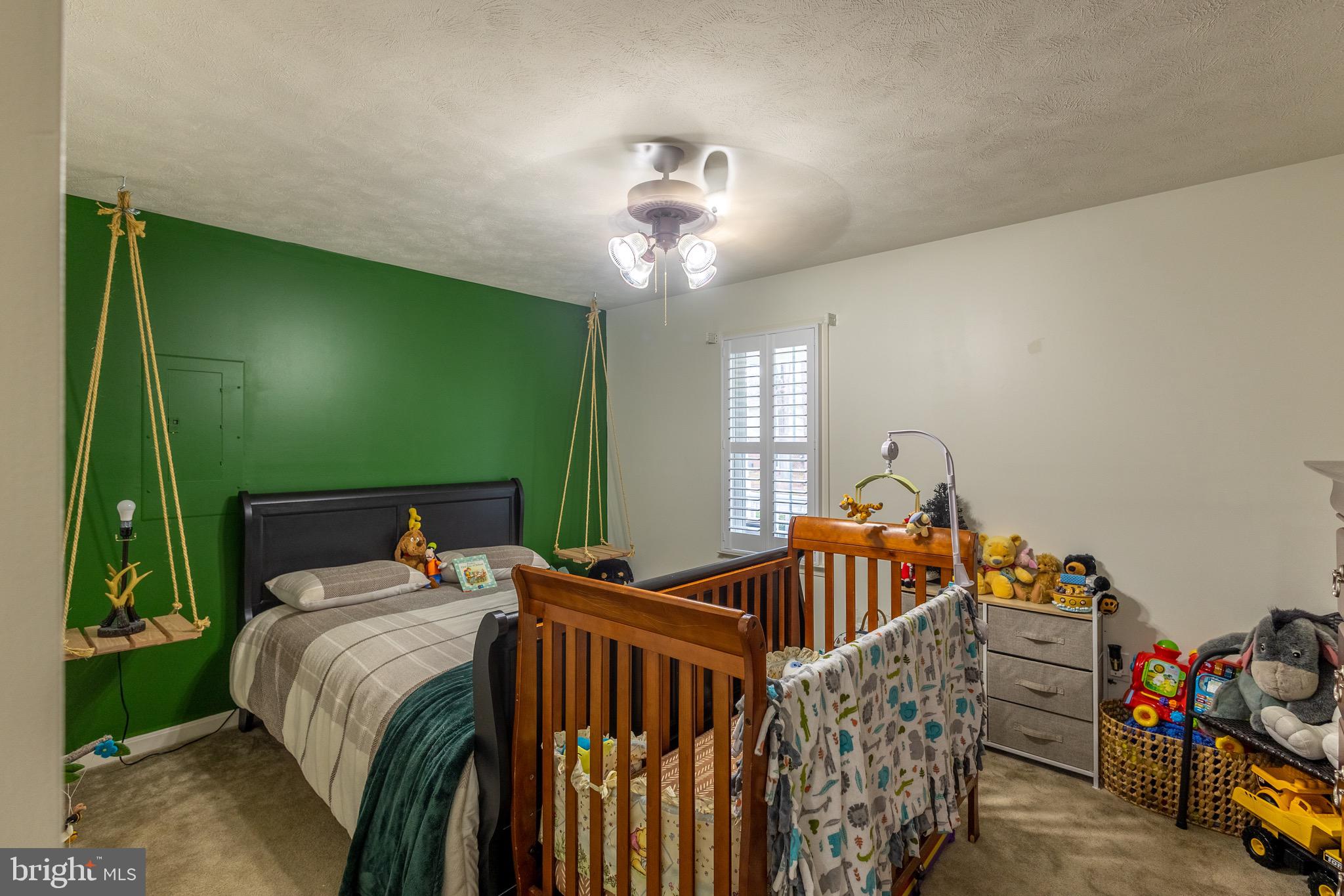 336 4th Street Colonial Beach, VA 22443 - Photo 23 of 23 a bedroom with a bed and a chandelier