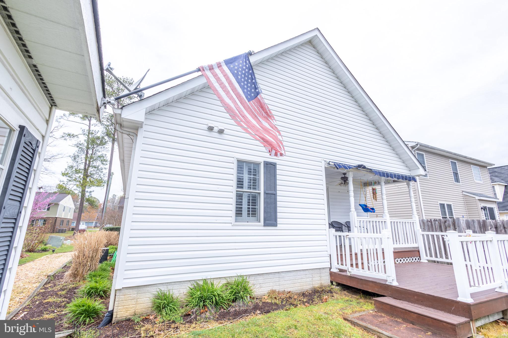 336 4th Street Colonial Beach, VA 22443 - Photo 8 of 23 a view of a house with a small yard and wooden fence