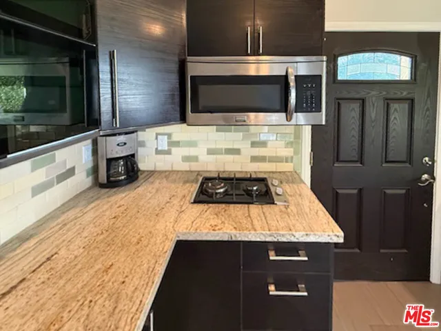 a kitchen with a stove and a microwave