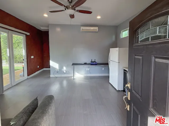 a view of a refrigerator in kitchen and livingroom