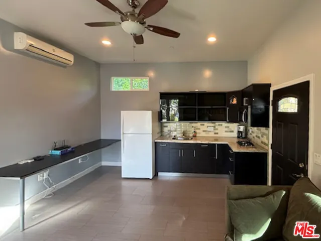 a kitchen with a stove and a refrigerator