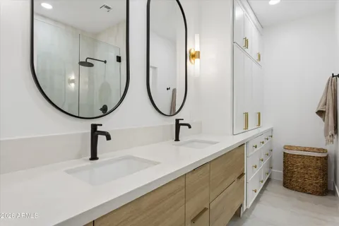 a bathroom with a double vanity sink and a mirror