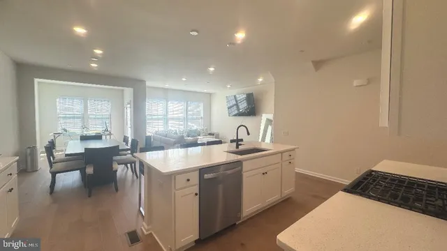 a kitchen with a sink and chairs