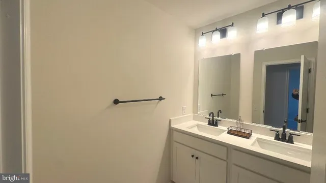 a bathroom with a double vanity sink and mirror