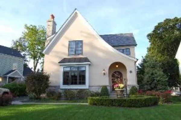 a front view of a house with a garden