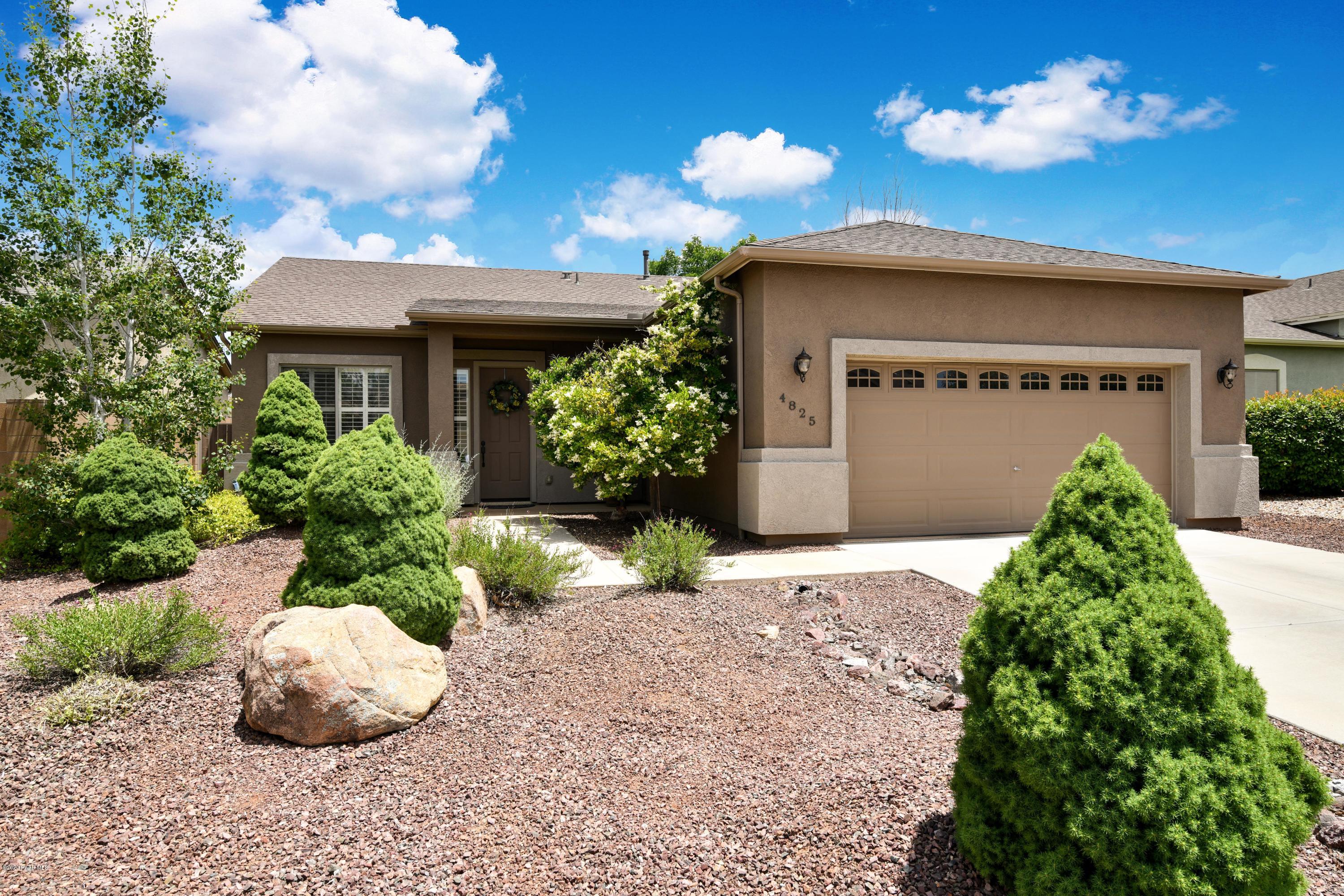 4825 Edgemont Road Prescott Valley, AZ 86314 - Photo 1 of 34 a front view of a house with a yard and potted plants