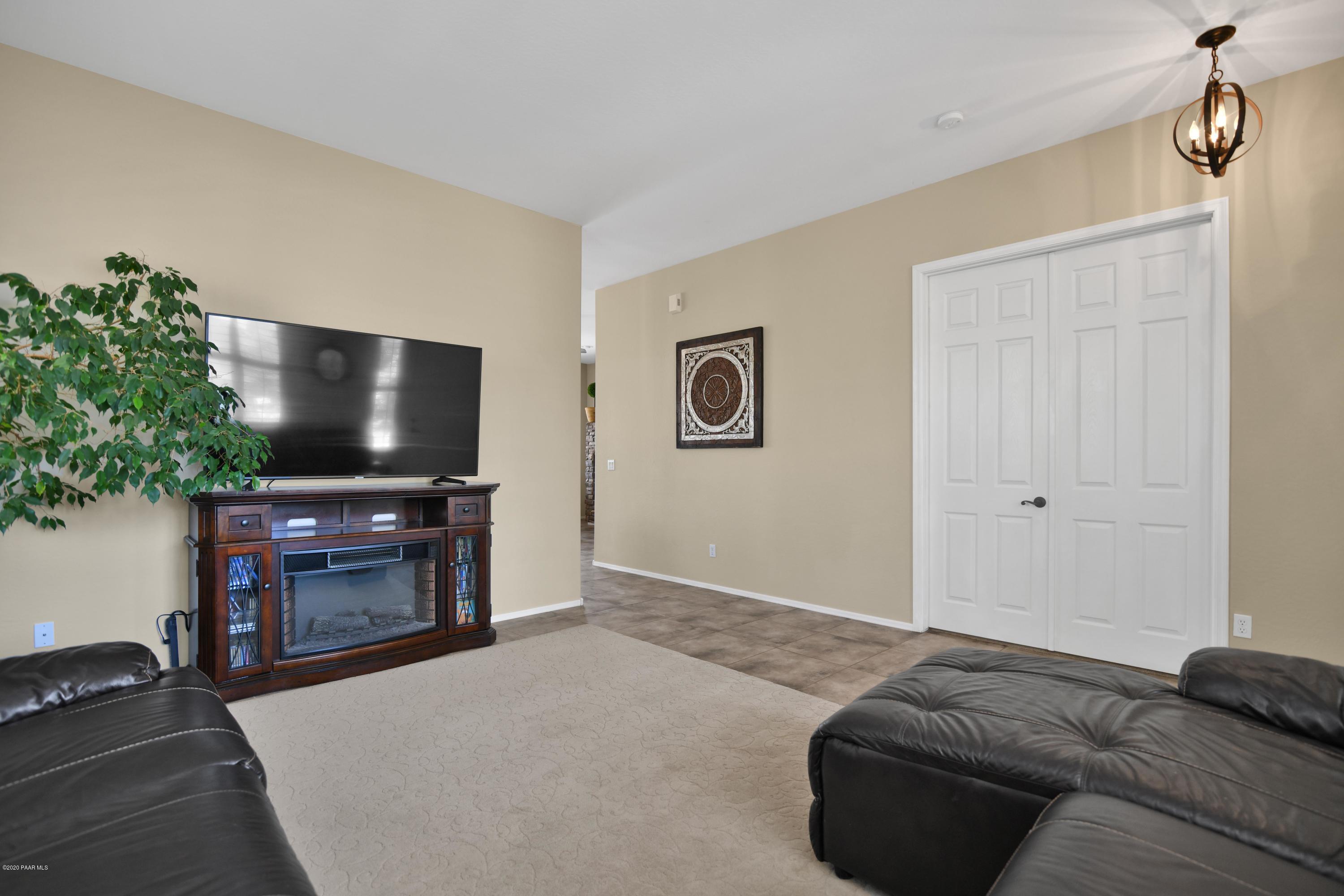 4825 Edgemont Road Prescott Valley, AZ 86314 - Photo 11 of 34 a living room with furniture and a flat screen tv