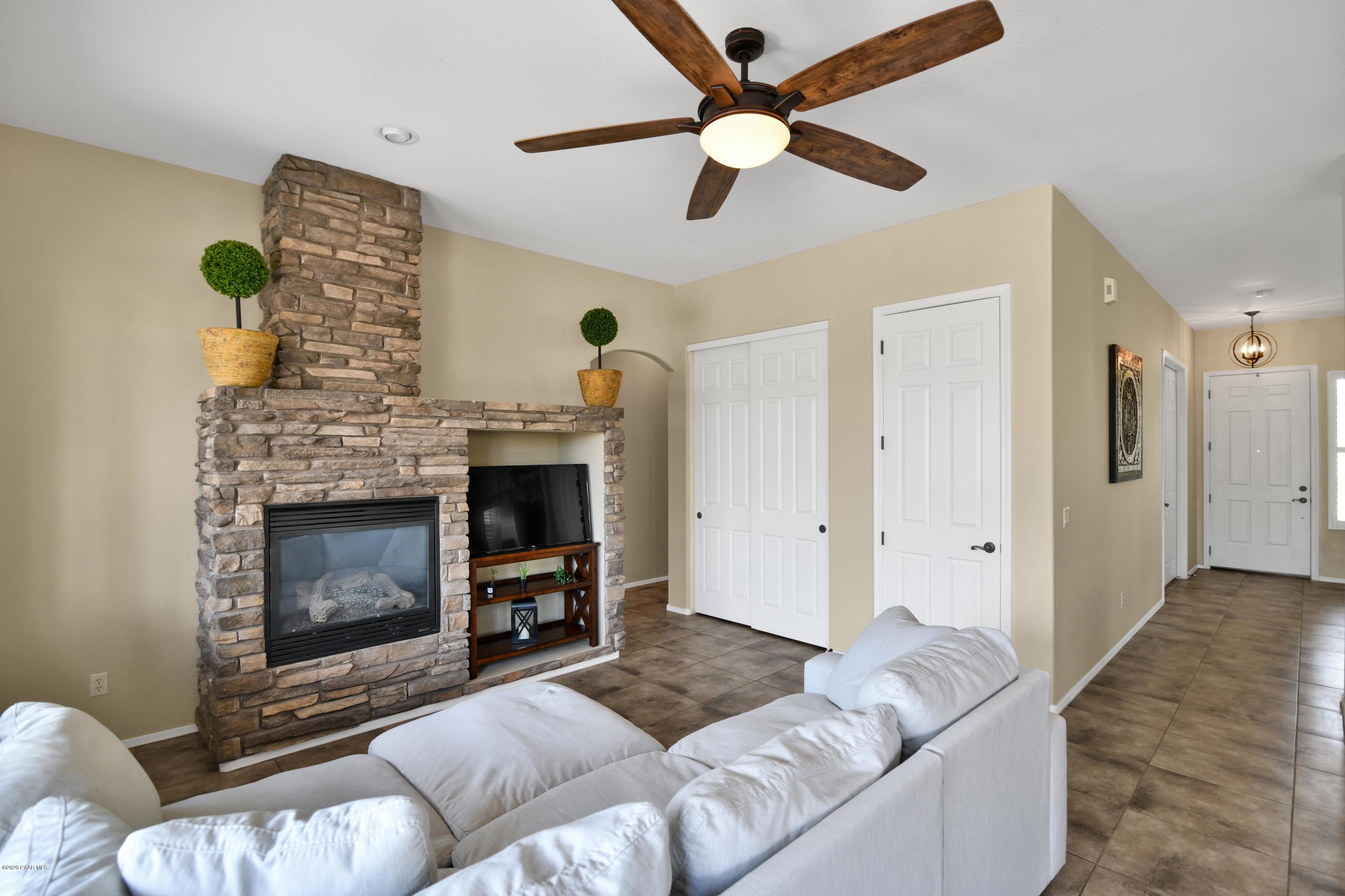 4825 Edgemont Road Prescott Valley, AZ 86314 - Photo 17 of 34 a living room with furniture and a fireplace
