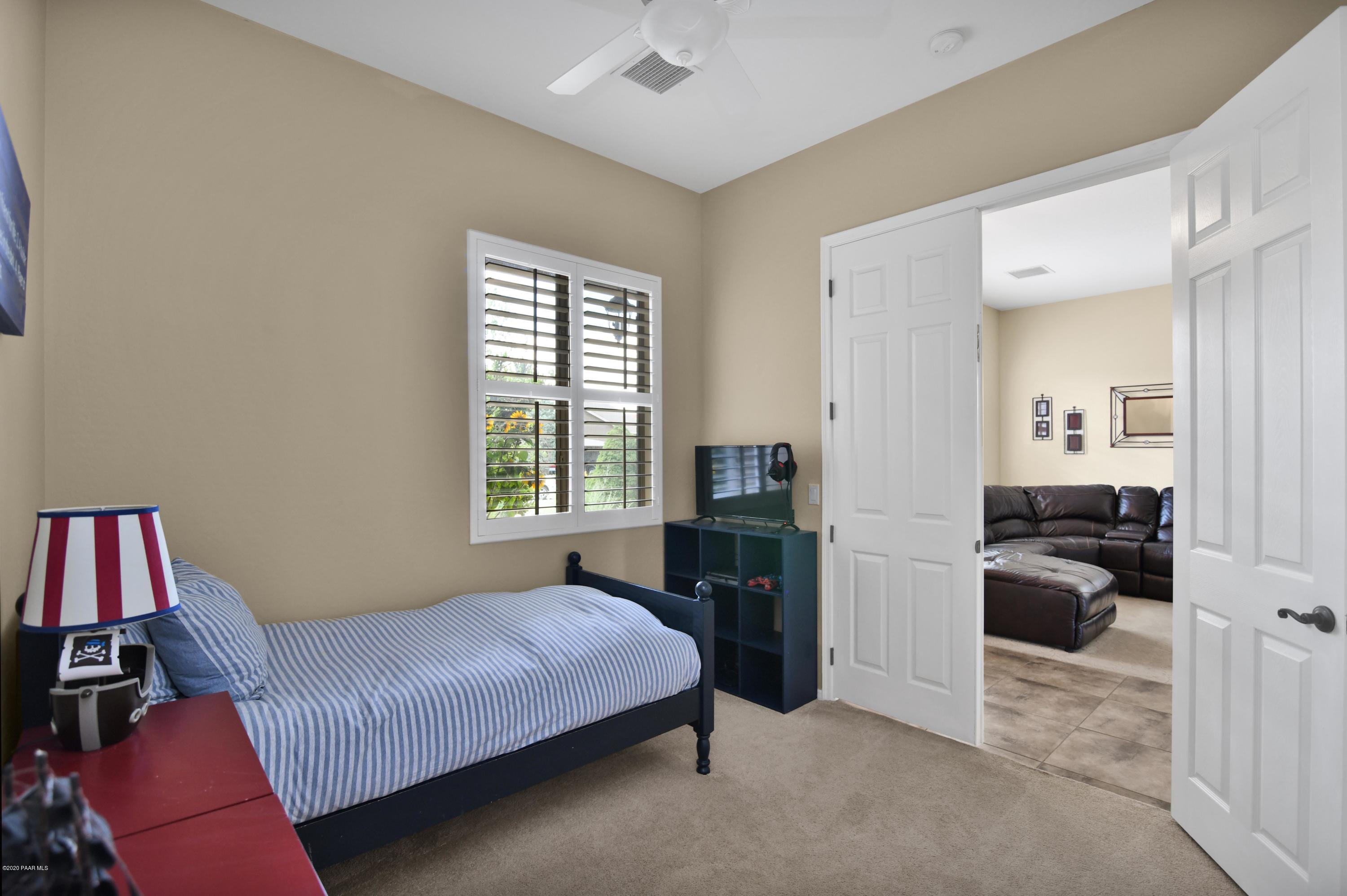4825 Edgemont Road Prescott Valley, AZ 86314 - Photo 26 of 34 a bedroom with a bed and a couch