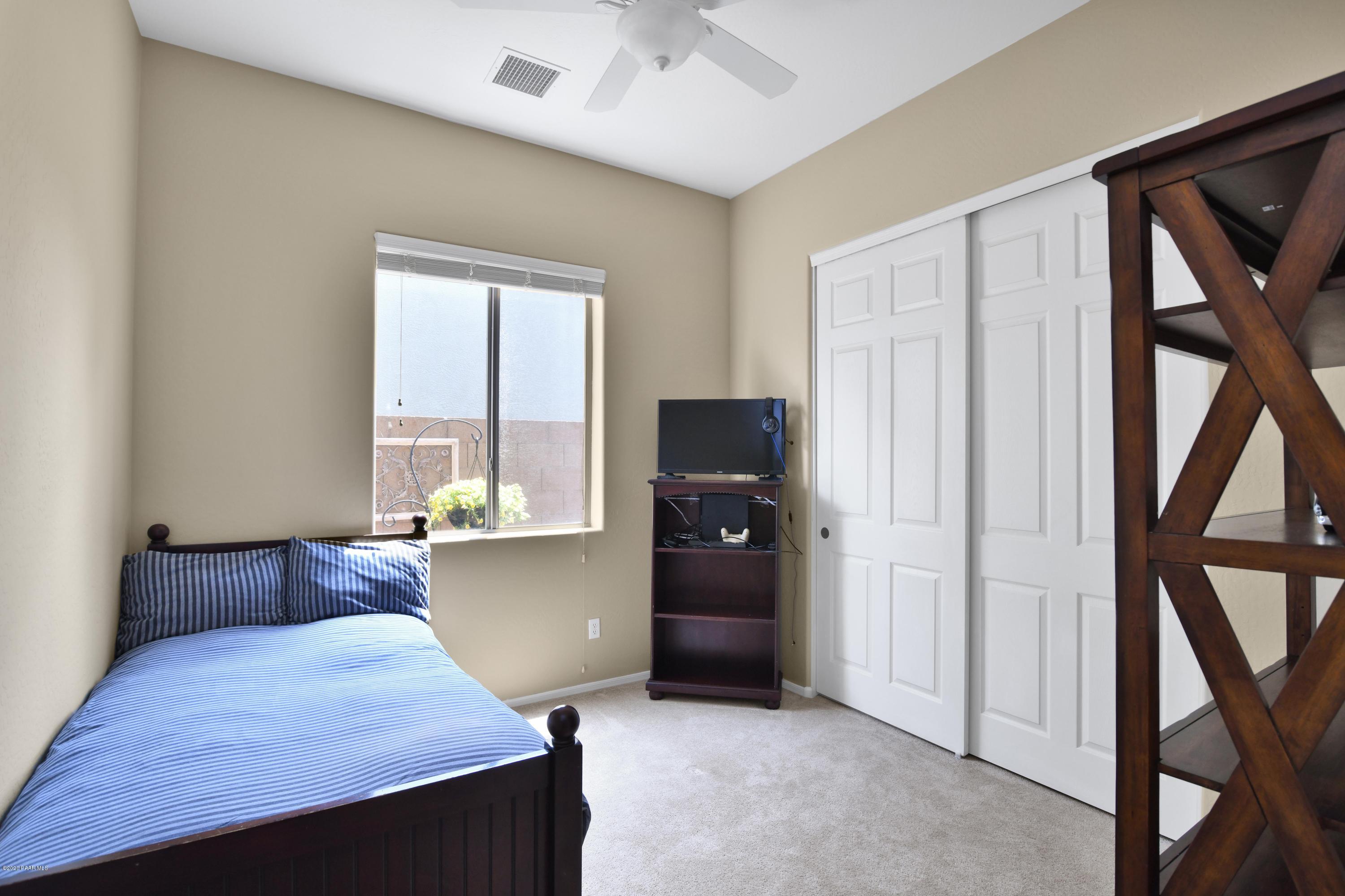 4825 Edgemont Road Prescott Valley, AZ 86314 - Photo 28 of 34 a bedroom with a bed and a window