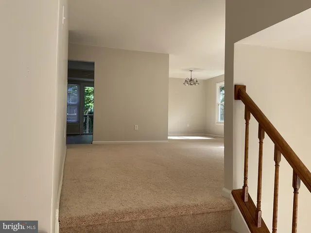 a white refrigerator freezer and a wooden floor in a kitchen