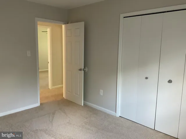 an empty room with closet area