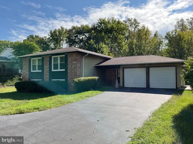a brick house with potted plants in front of it