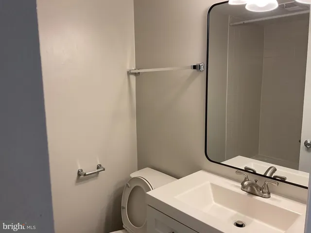 a view of empty room with stairs and wooden floor