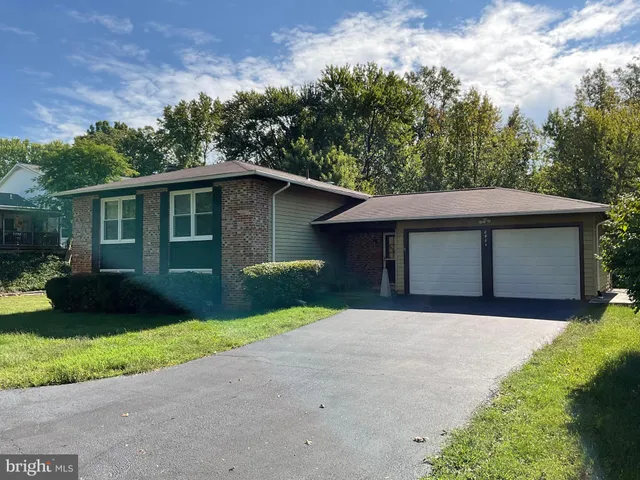 a view of a room with wooden floor and white walls