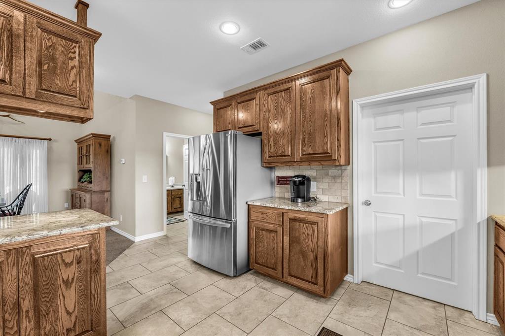 613 Bone Road Valley Mills, TX 76689 - Photo 12 of 40 a kitchen with stainless steel appliances granite countertop a refrigerator and a stove top oven