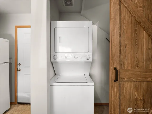 a close view of a utility room with dryer and washer