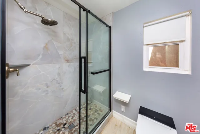 a bathroom with a shower and a toilet