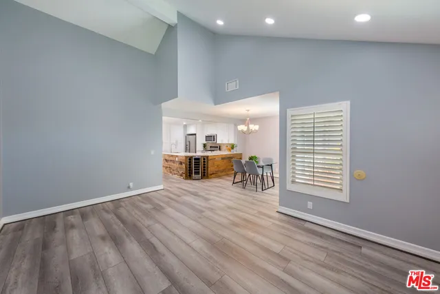 a view of a livingroom with wooden floor and furniture