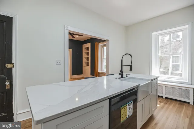 a view of a kitchen with a sink and cabinets