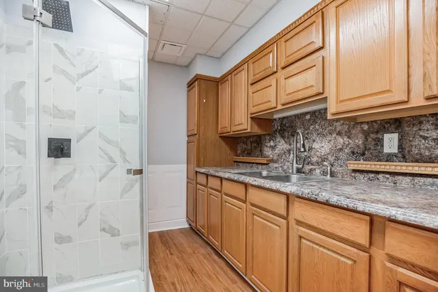 a kitchen with stainless steel appliances granite countertop a sink a stove and cabinets