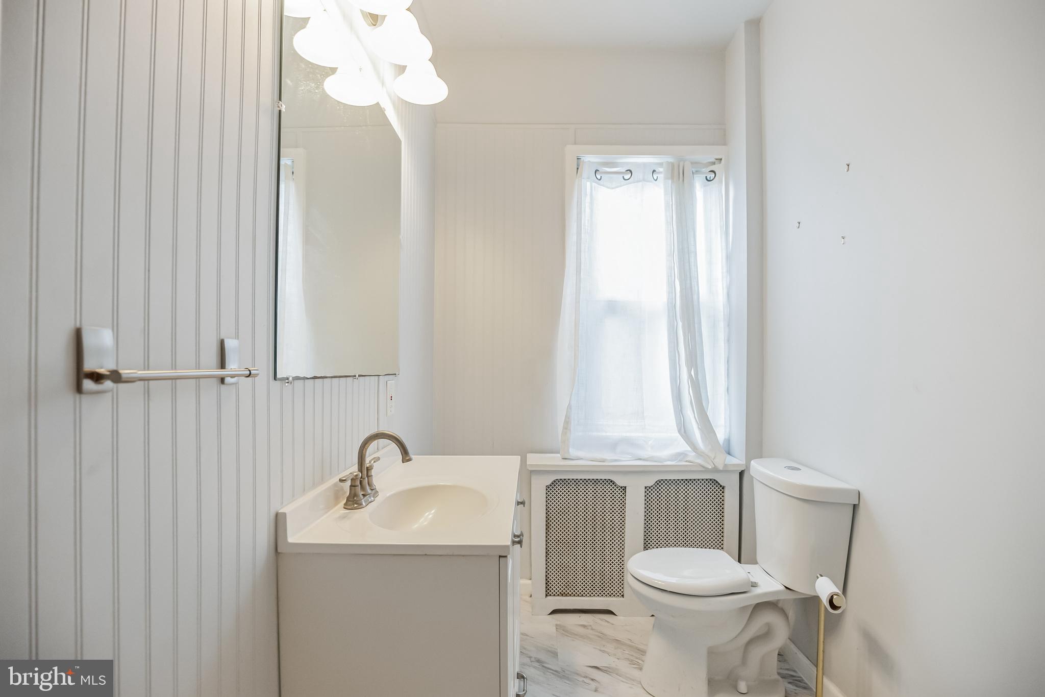 117 Rochelle Avenue Philadelphia, PA 19128 - Photo 15 of 29 a bathroom with a toilet sink and mirror