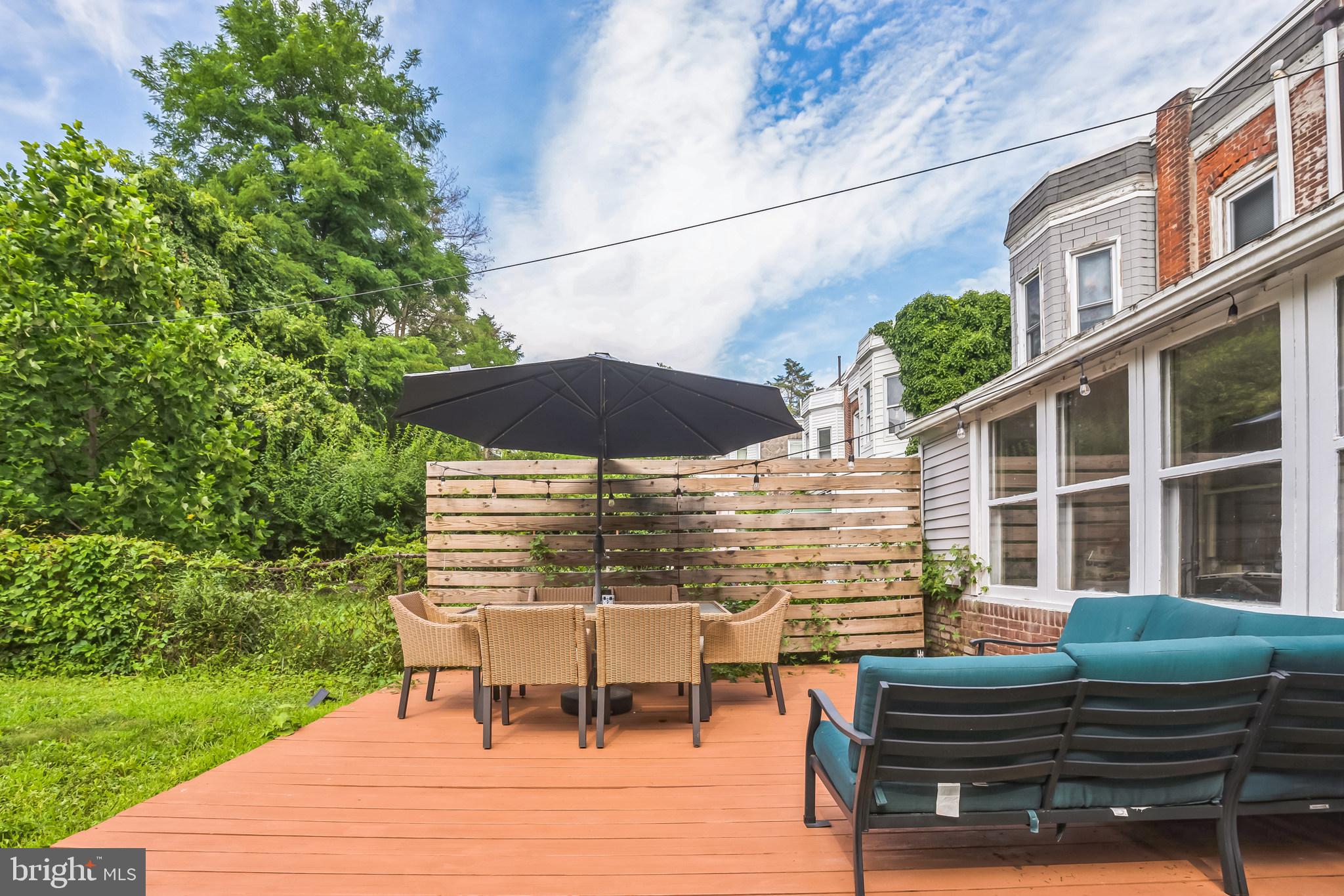 117 Rochelle Avenue Philadelphia, PA 19128 - Photo 23 of 29 a view of a patio with table and chairs under an umbrella