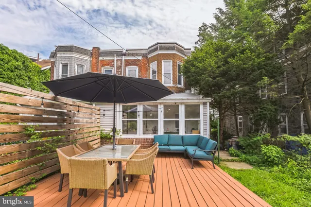 a view of a house with backyard and sitting area