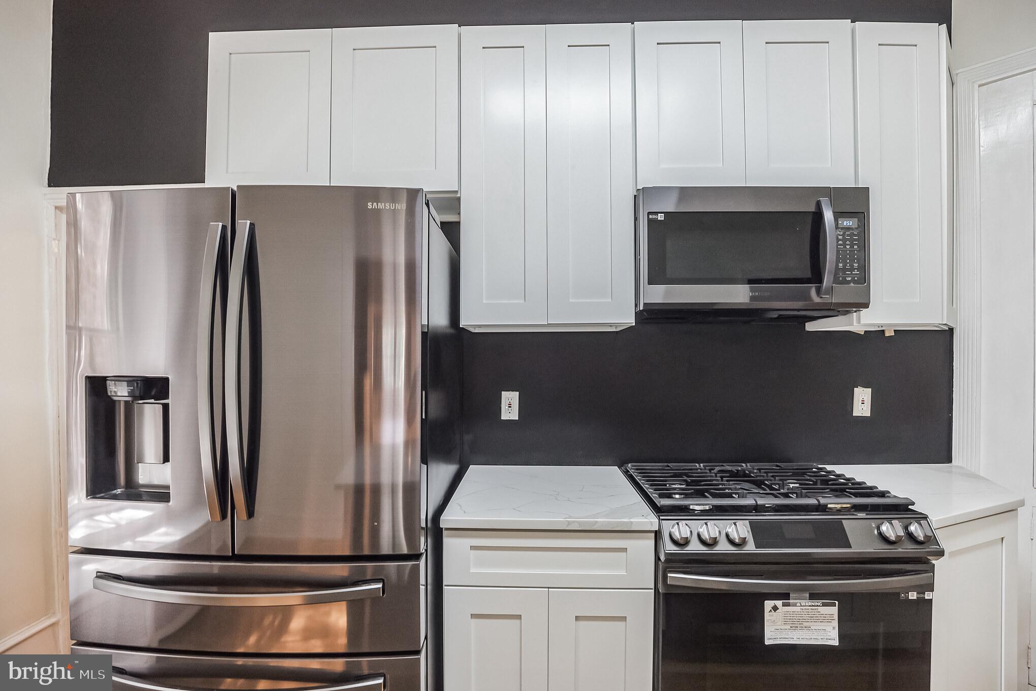 117 Rochelle Avenue Philadelphia, PA 19128 - Photo 10 of 29 a kitchen with a stove and a microwave