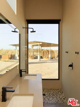 a view of a balcony with chairs and front door