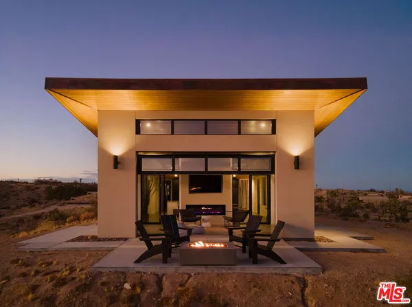 a view of a pool with outdoor seating