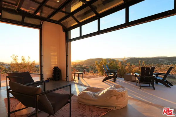 a view of a chairs and table in patio